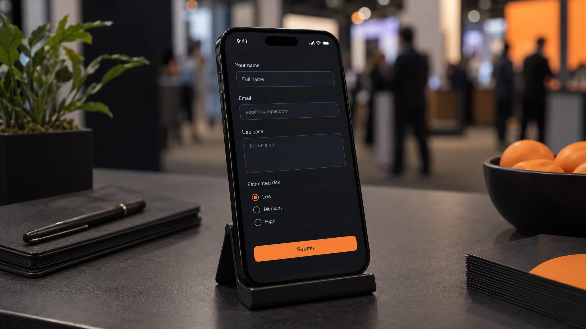 Phone on a stand at an event table showing a short mobile form